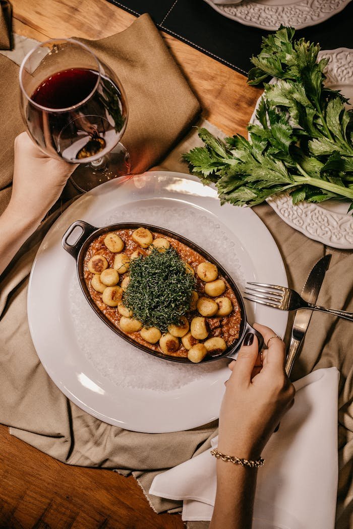 Plate of Food next to glass of red wine